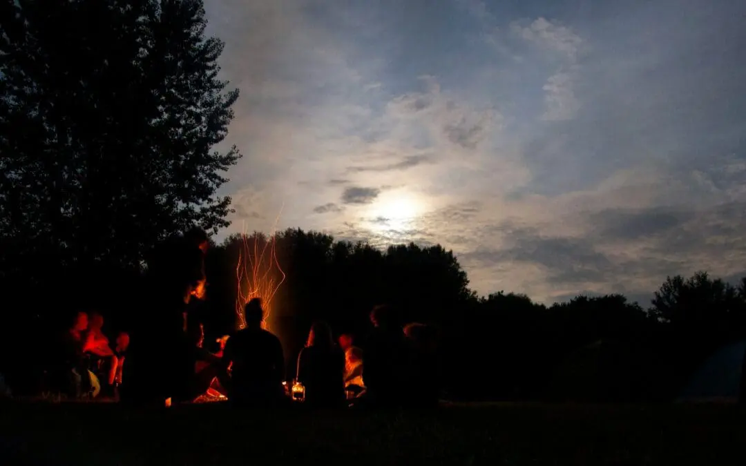 Group of people around a campfire.